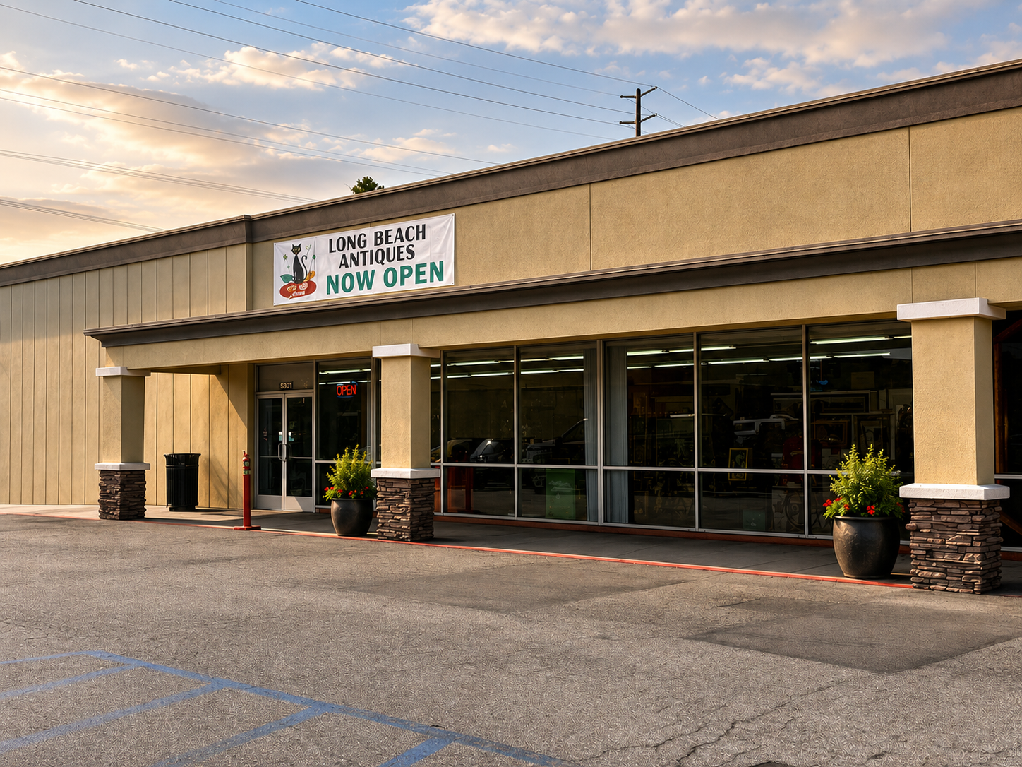 Storefront with 'Long Beach Antiques' sign indicating it is now open, with a clear sky above.