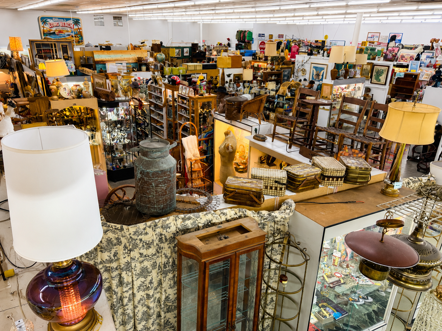 Vintage store with various items including lamps and furniture.