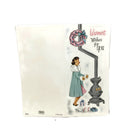 Vintage holiday greeting card featuring an illustration of an African American woman with a Christmas tree, with text 'Warm Wishes for You'.
